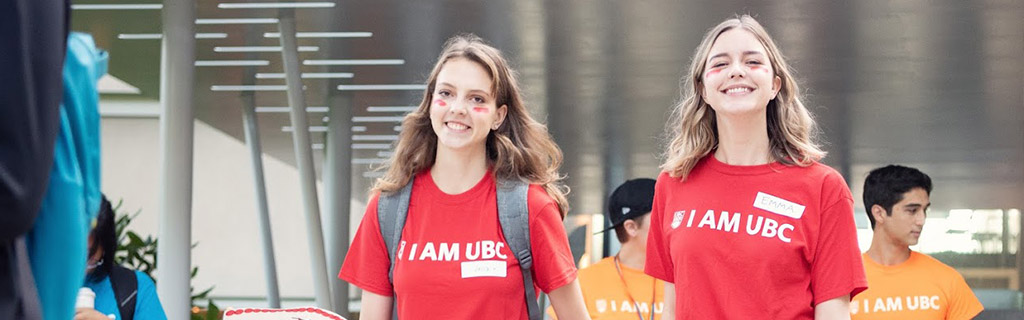 Students smiling in I AM UBC shirts