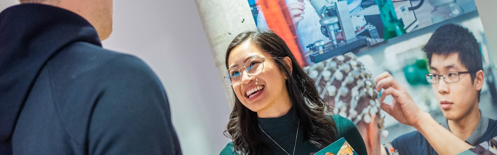 Girl speaking to student about programs