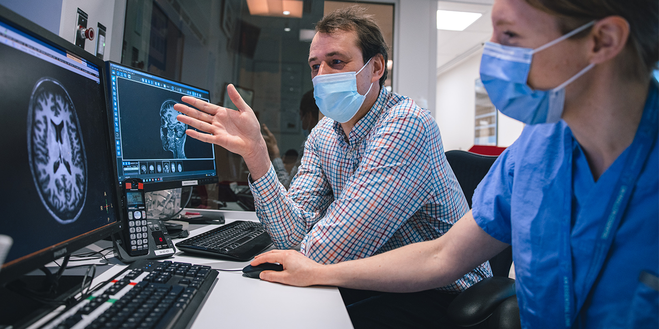 UBC Researchers review brain data being displayed on computer monitors in the MRI Research Centre