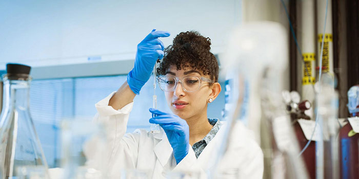 Student in lab using a micropipette