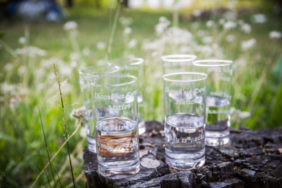 Glasses engraved with 'Too bets`huna,' meaning ‘We live by water’ celebrate the new treatment system.