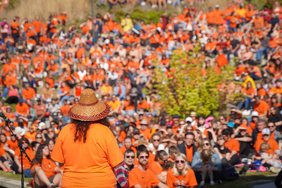 Dana-Lyn Mackenzie speaking to attendees at UBC's Orange Shirt Day intergenerational march.