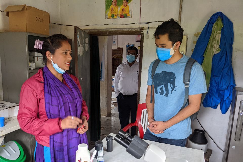 Pranav Shrestha discusses sickle cell research with a healthcare worker in Nepal