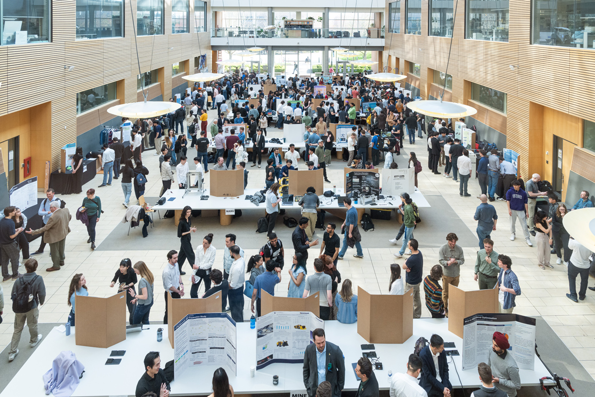 A view of the lobby of the Life Sciences Building, with crowds around the many project displays.