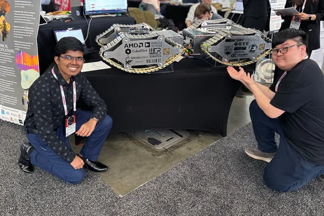 Students pose with EMBR robot
