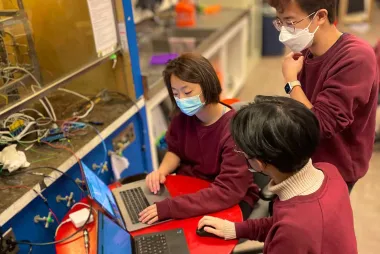 Three Mars Colony team members working on together on their laptops.