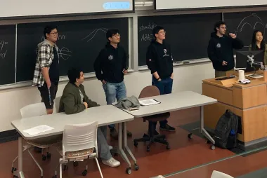 Open Robotics team members giving a talk at the front of the classroom