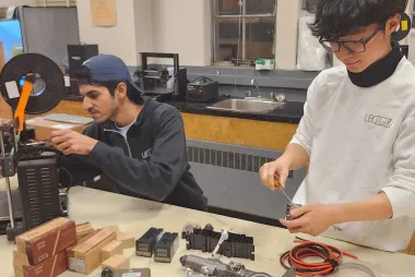 Two Rapid members in the workshop working on a prototype
