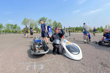Team member with prototype vehicle