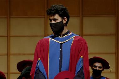 ECE PhD Student Mohammad Jafari is seen on stage in his UBC Regalia at the graduation ceremony