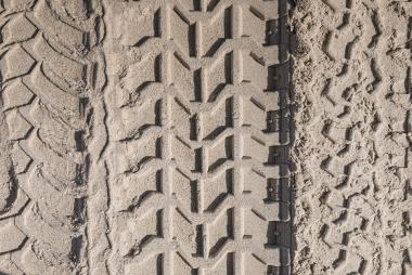 Vertical rubber tire tracks in sand
