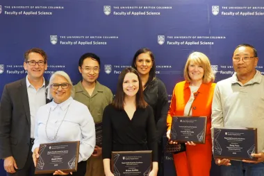 Dean James Olson stands with six recipients of the 2023 Dean's Awards for faculty and staff members