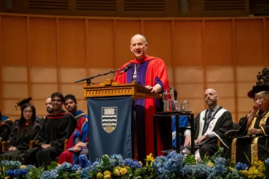 Erik Lindholm addresses UBC's graduates while wearing his graduation regalia