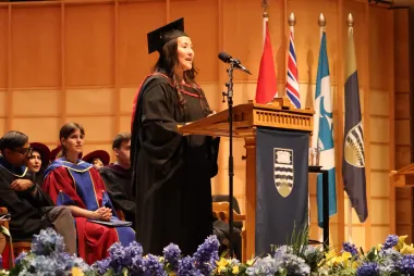 Nomi Danzig speaks on stage at graduation