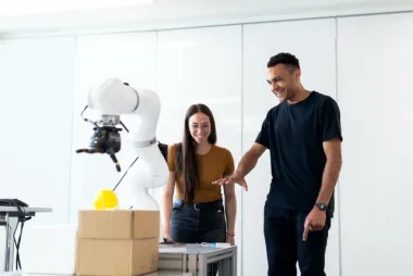 Two people working on a robot