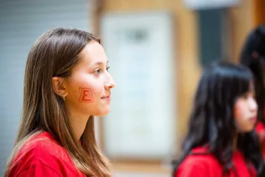 Female engineering student with E temporary tattoo on her face