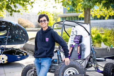 Student in front of UBC Baja vehicle