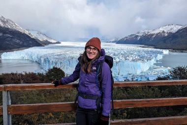 Photo of Rebecca in front of a glacier and mountains