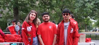 3 students Pose together in Engineering red.