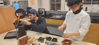 Two Rapid members in the workshop working on a prototype