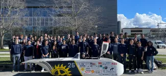 Team photo with solar car.