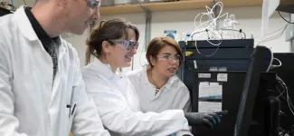 three students working in a lab