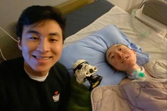 UBC Engineering grad Michael Ko smiles for the camera alongside his brother Daniel and a LEGO Stormtrooper figurine.