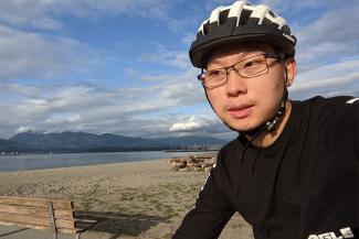 UBC Engineering Physics alumnus James Wu biking along Jericho Beach