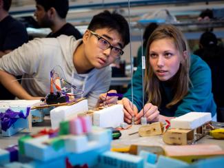 Two UBC mechanical engineering students prepare for the autonomous landing platform competition.