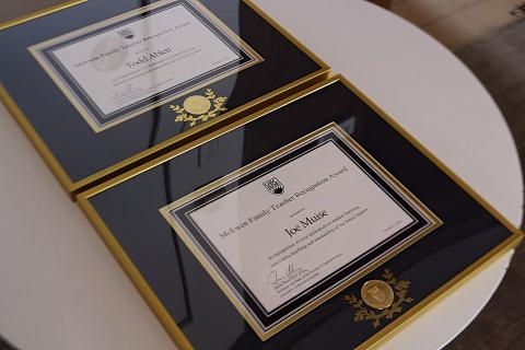 Framed awards recognizing the 2022 McEwen Family Teacher Award winners are displayed on a table