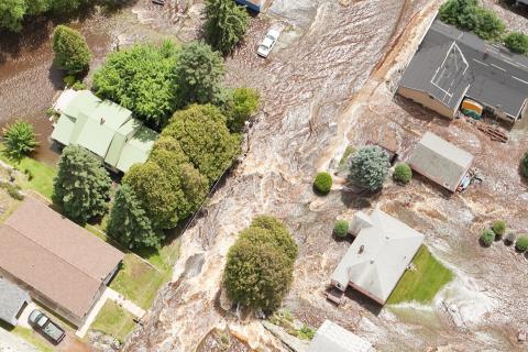 Aerial image overlooking flood damage to houses and trees