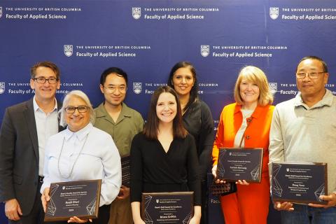 Dean James Olson stands with six recipients of the 2023 Dean's Awards for faculty and staff members