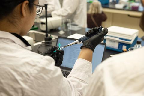 A student working with tools in a lab