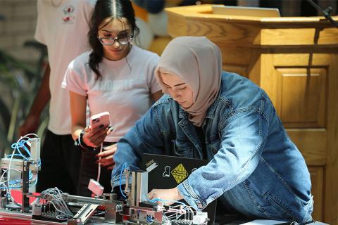 Reema Abdullah and students from a Kelowna Secondary School Engineering 12 class demonstrate their mechatronics project at UBCO. (Credit: UBC Okanagan School of Engineering)