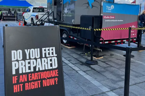 A sandwich board reading "Do you feel prepared if an earthquake hit right now?"
