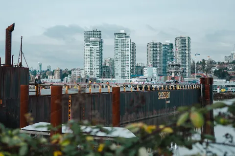 A Seaspan Ferries barge and tugboat overlook the New Westminster waterfront