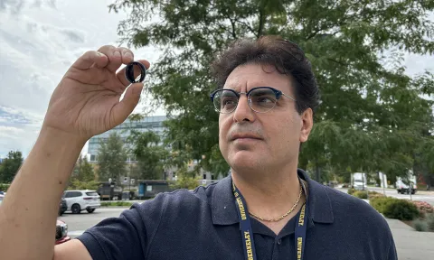 Dr. Hadi Mohammadi holds up a mechanical heart valve