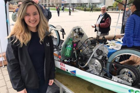 Talisha Griesbach beside a UBC Supermileage vehicle