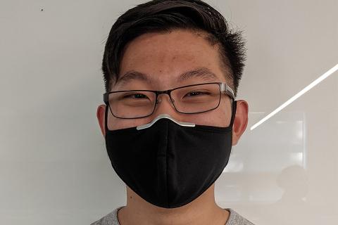 UBC Engineering Physics alumnus James Wu smiles for the camera while wearing a black face mask