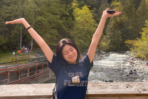 Pan, smiling in front of beautiful nature sceneries