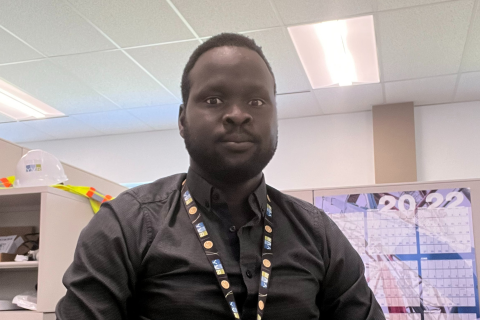 Samuel, smiling at his work office