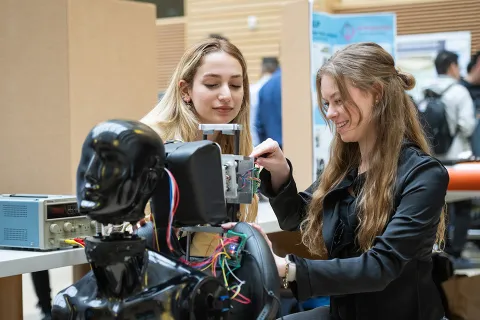 Two students working on a robot
