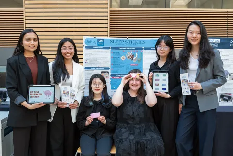 Students standing in front of their project poster
