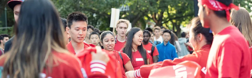 Students handing out EUS merch
