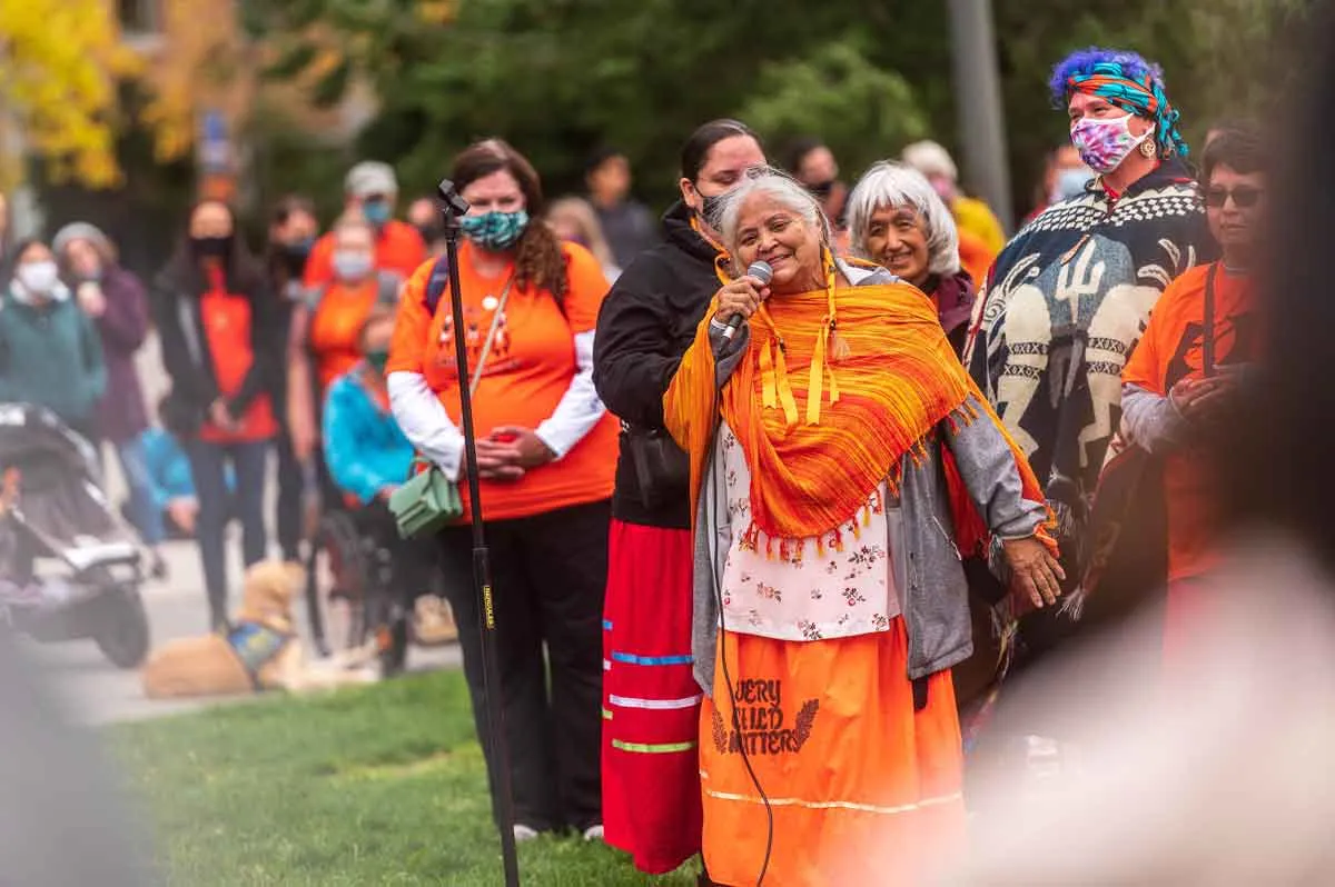 Elder Pauline 'Fishwoman' Johnson shares a story with the Orange Shirt Day Crowd