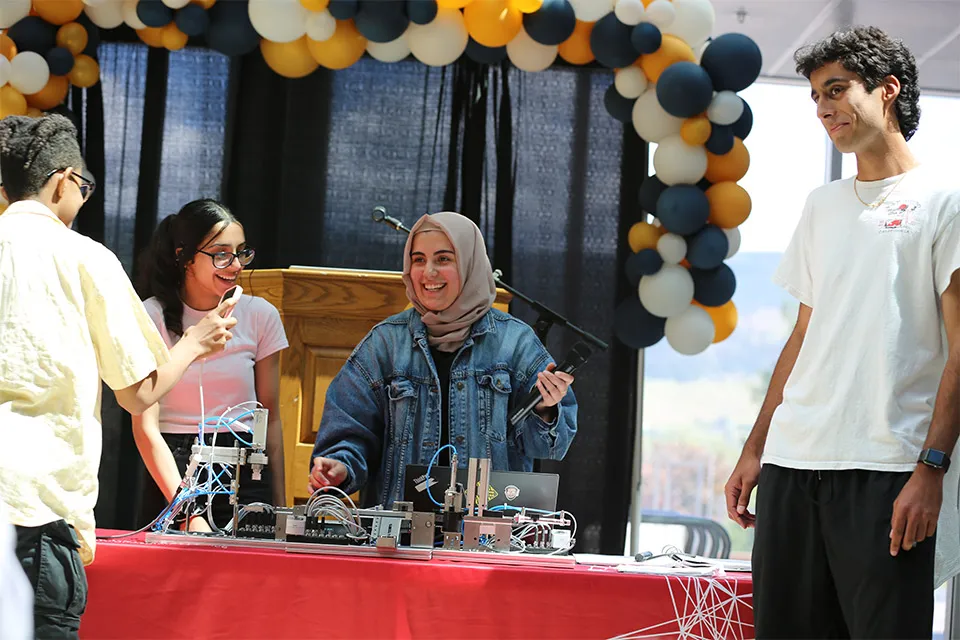 Reema Abdullah and students from a Kelowna Secondary School Engineering 12 class demonstrate their mechatronics project at UBCO.