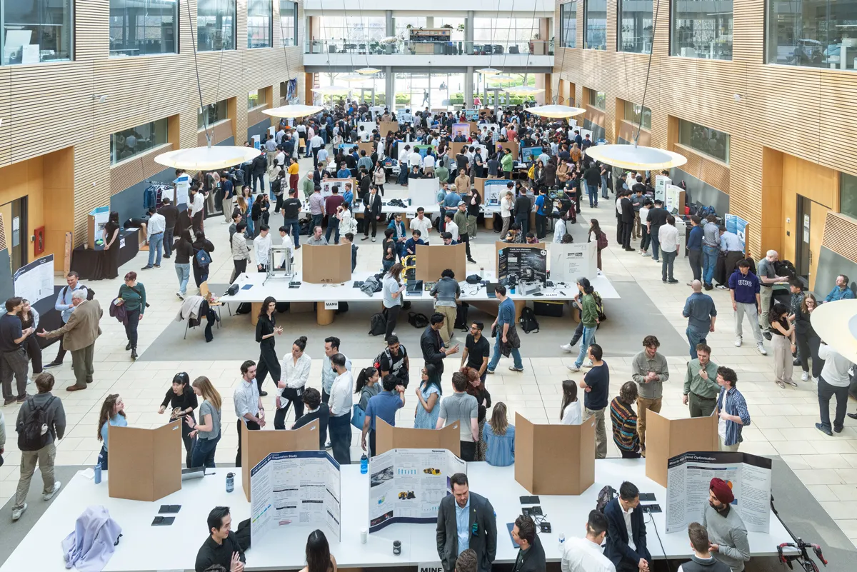 A view of the lobby of the Life Sciences Building, with crowds around the many project displays.