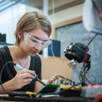 Electrical engineering student working on her circuit board